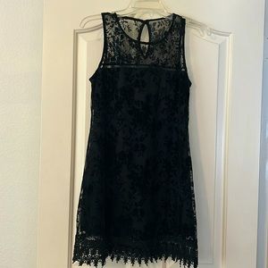 Black slip dress with button closure at the neck